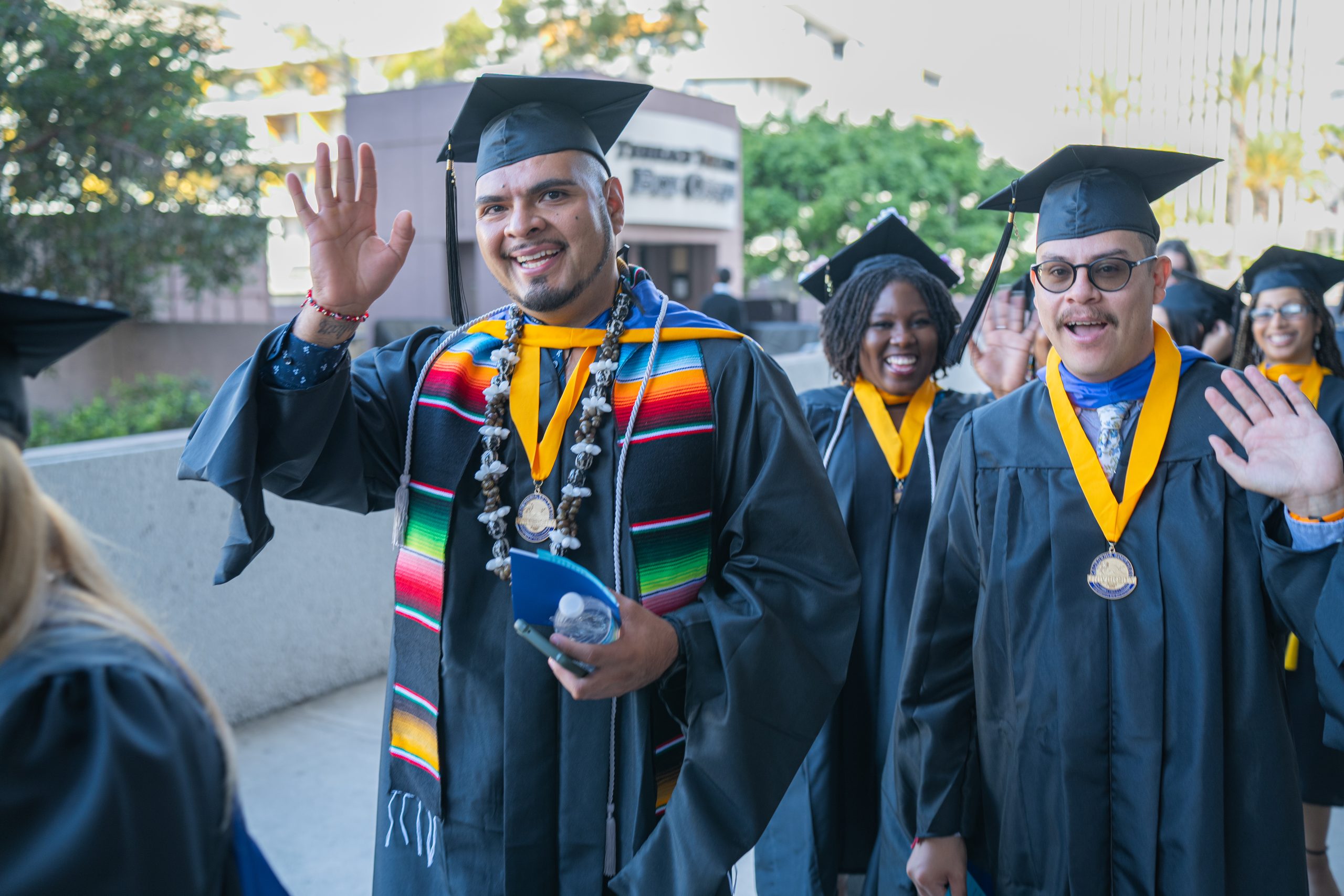 CalSouthern graduates walking and waving